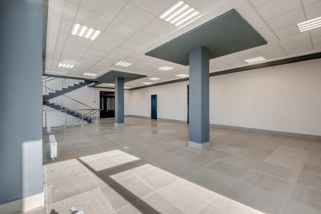 empty modern hall room with columns, doors and panoramic windows.