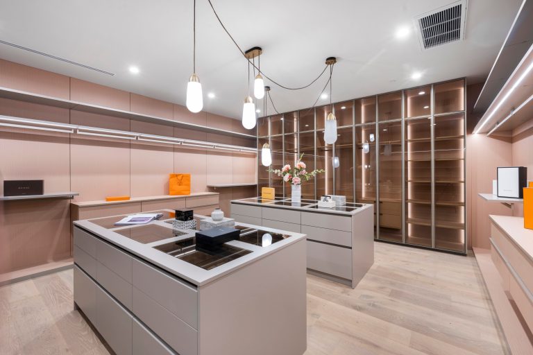 Modern luxury walk-in closet with stylish lighting